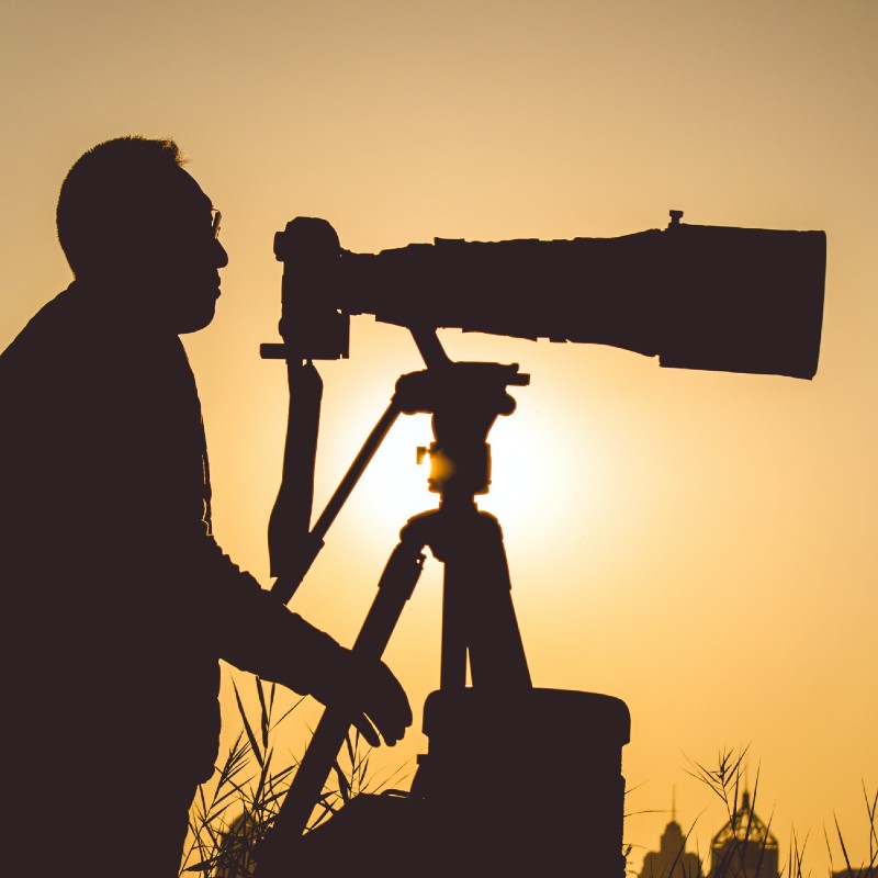 man with telescopic lens