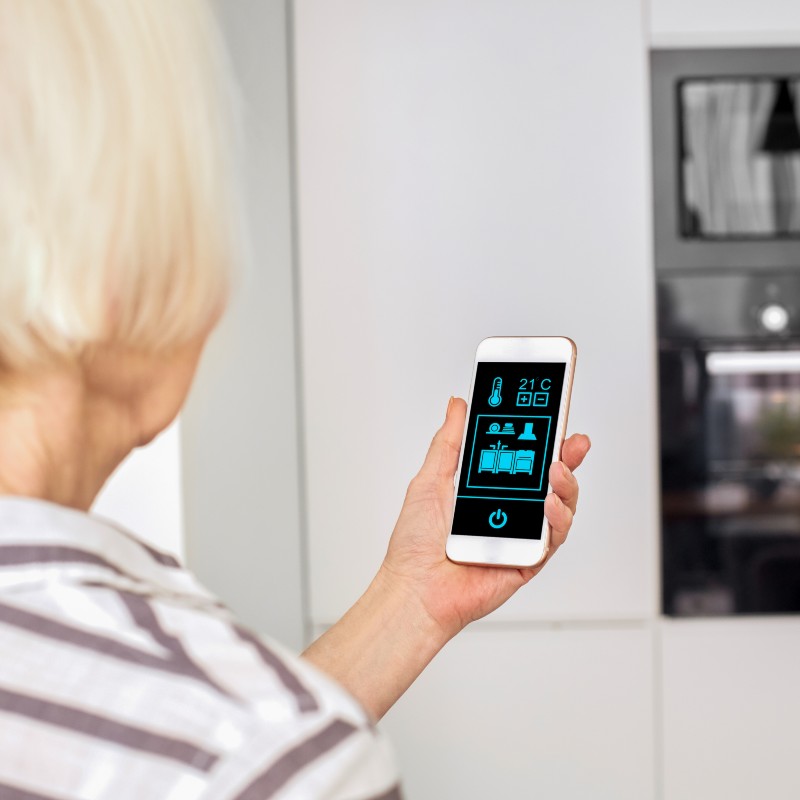 older woman using an app for cooking